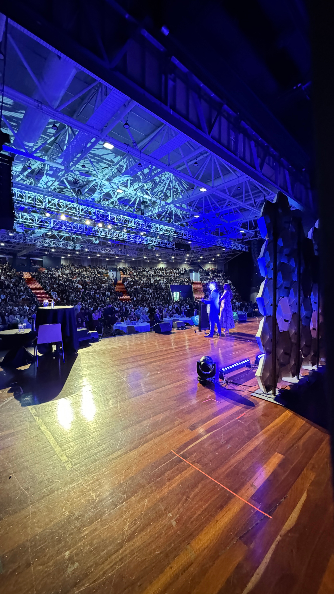 Zac and Jill Newell speaking to a packed audience