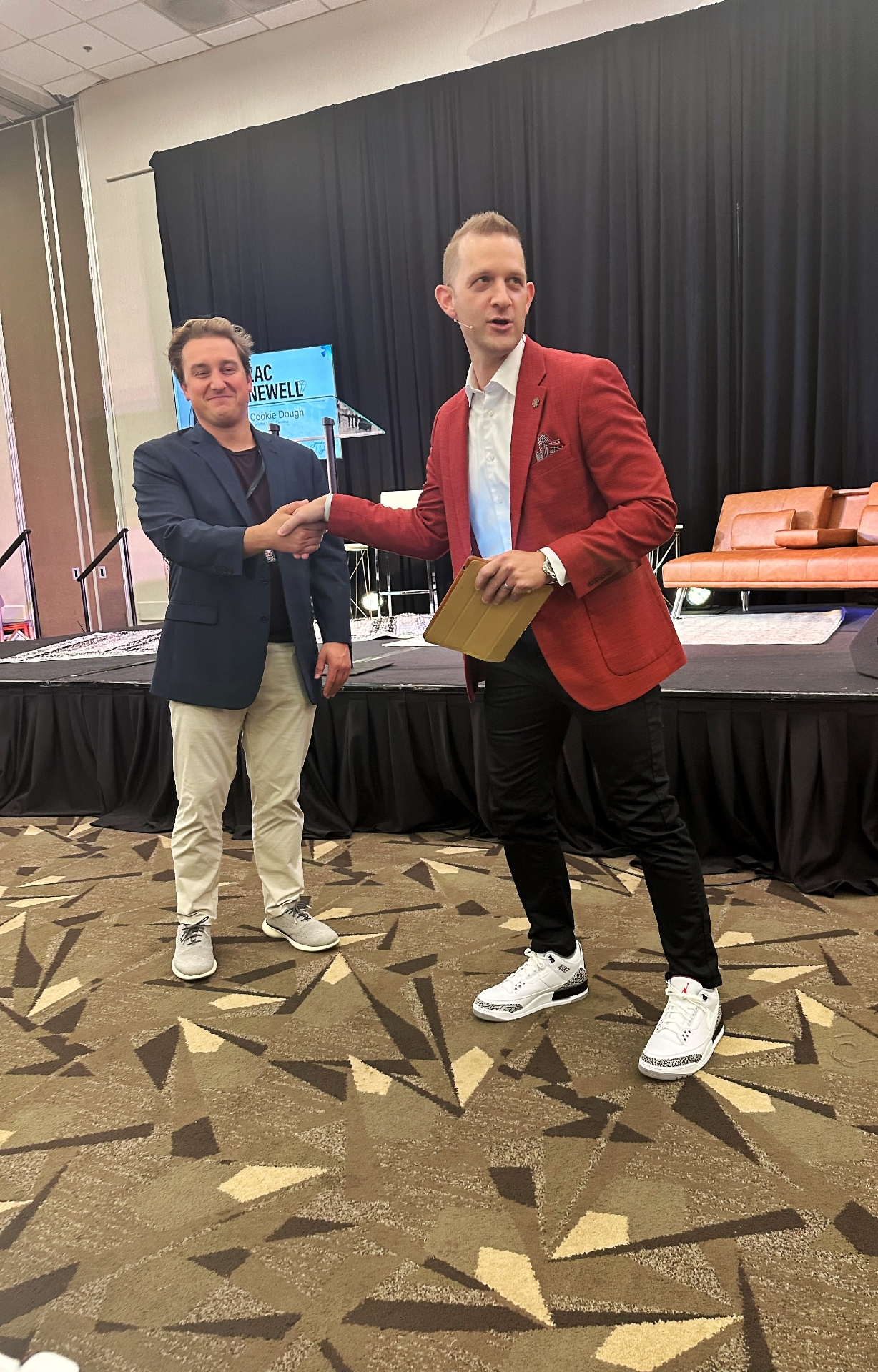 Zac Newell shaking hands with an attendee after speaking