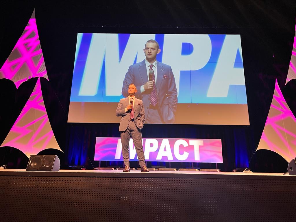 Zac Newell speaking solo on the IMPACT stage