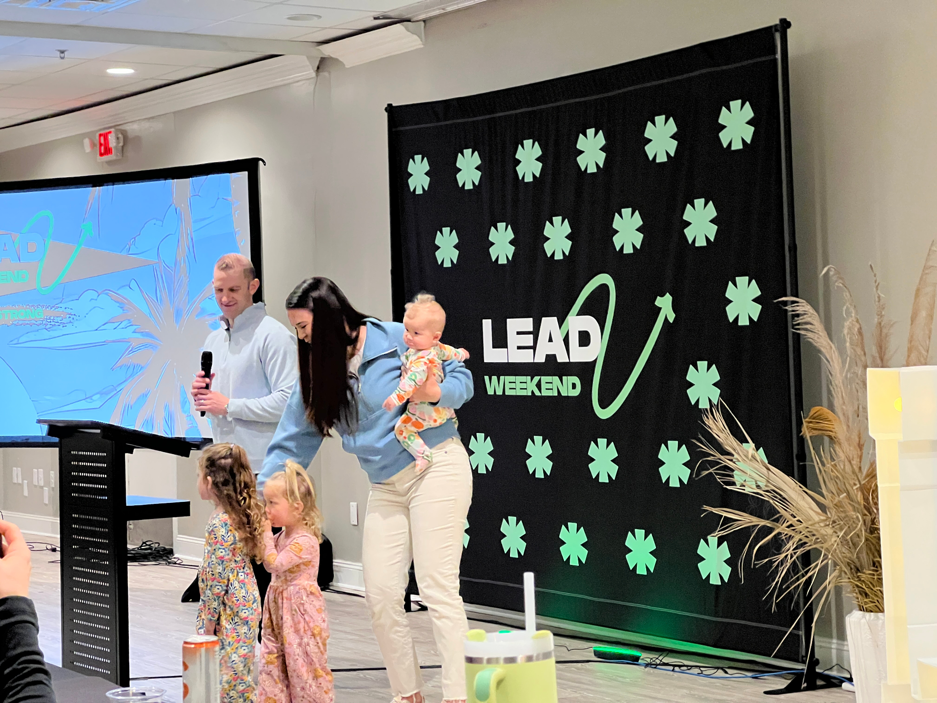 Zac and Jill Newell with their children on stage