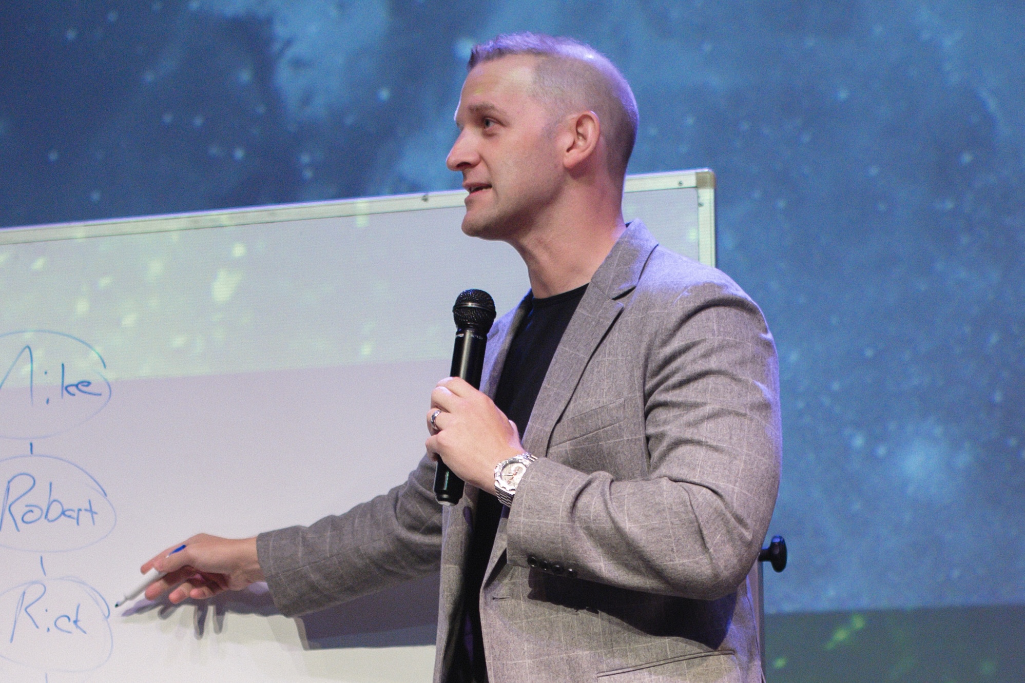 Zac Newell teaching from a whiteboard during a live workshop